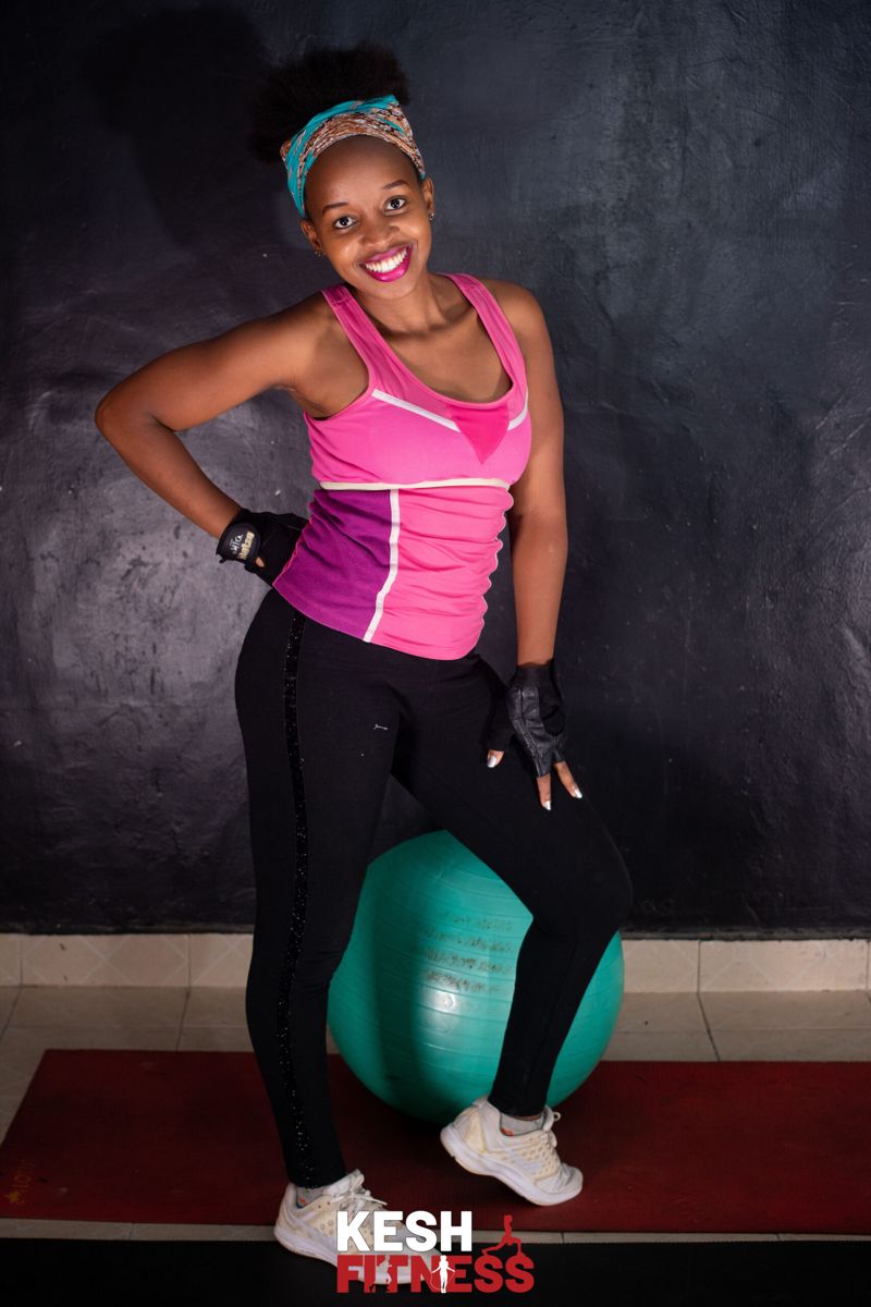 Coach Kesh smiling with an exercise ball